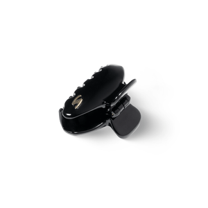 Sacrae Eva claw clip glossy black — worn pinned back at the side