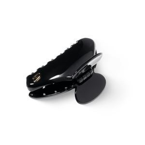 Lumière Medium Hair Clip glossy black — editorial overhead shot