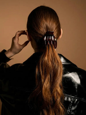 Sacrae Marina Medium Claw Clip in Tortoise holding a low ponytail, back view