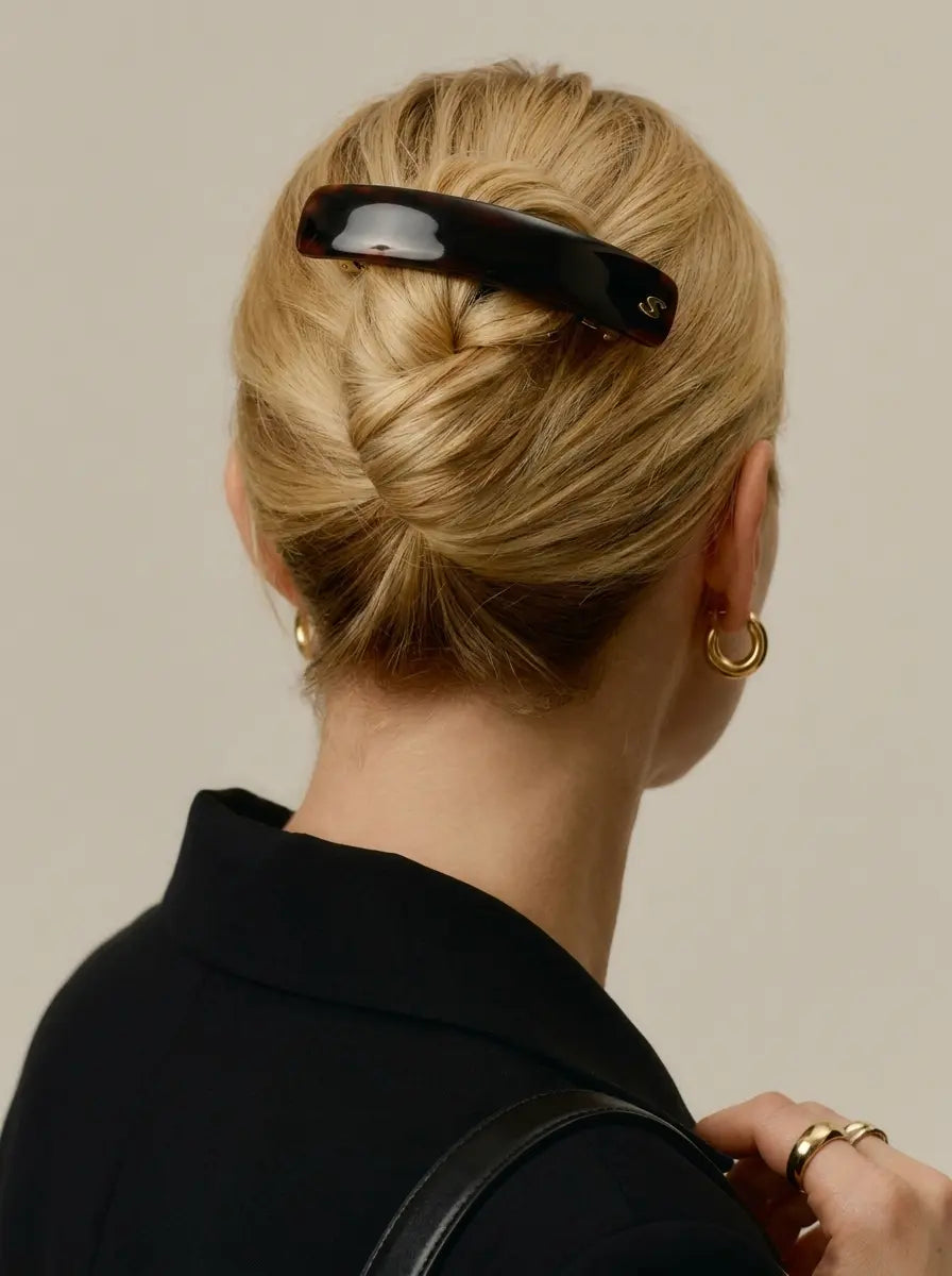Model wearing Sacrae Jonc Majesté Barrette in Tortoise, French twist, back view