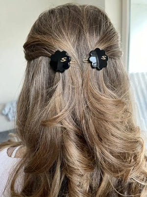 Model wearing Sacrae Petite Fleur Clips in Glossy Black, half-up hairstyle, back view