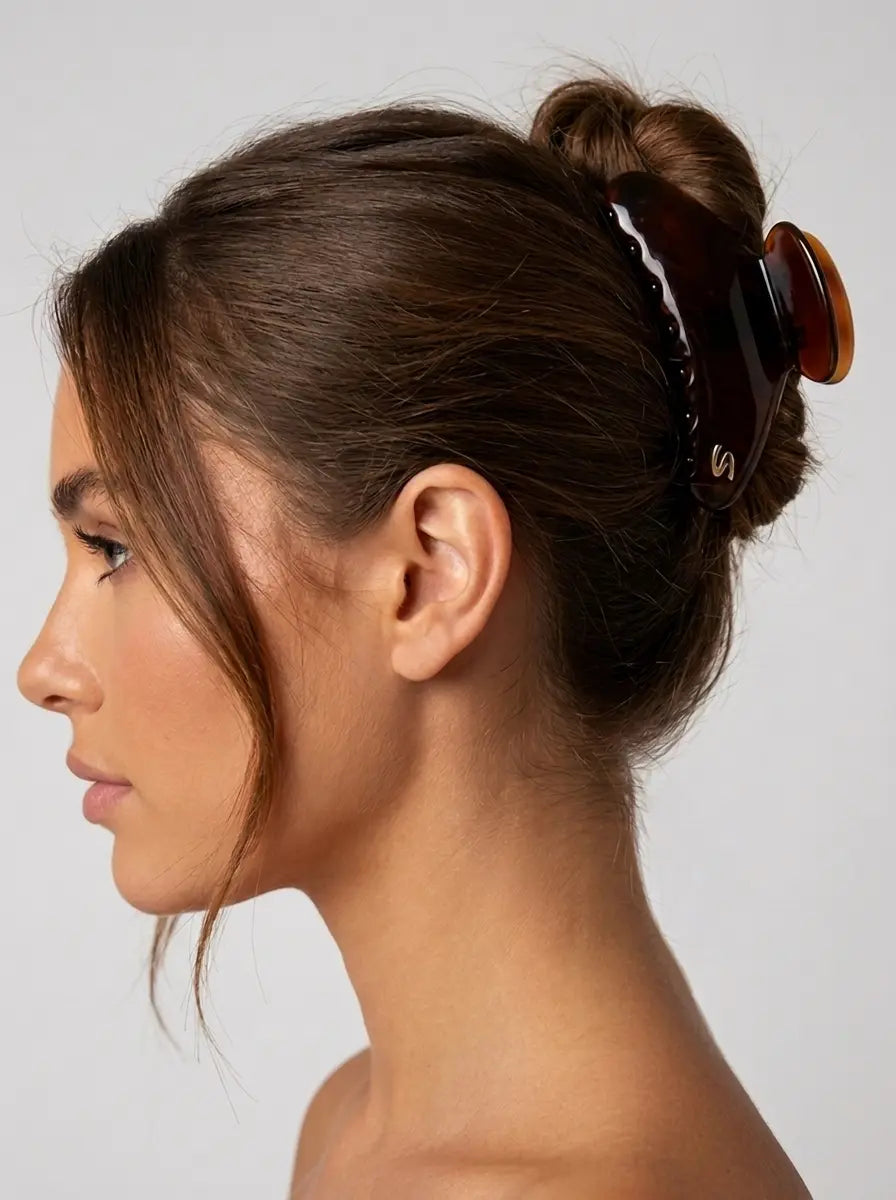 Model wearing Sacrae Lumière Medium Hair Clip in Tortoise, bun hairstyle, side view