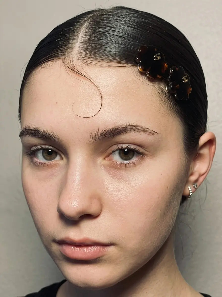 Model wearing Sacrae Petite Fleur Clips in Tortoise, sleek hairstyle, front view