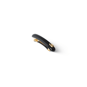 Sacrae Jonc Slim glossy black — worn flat against a low bun