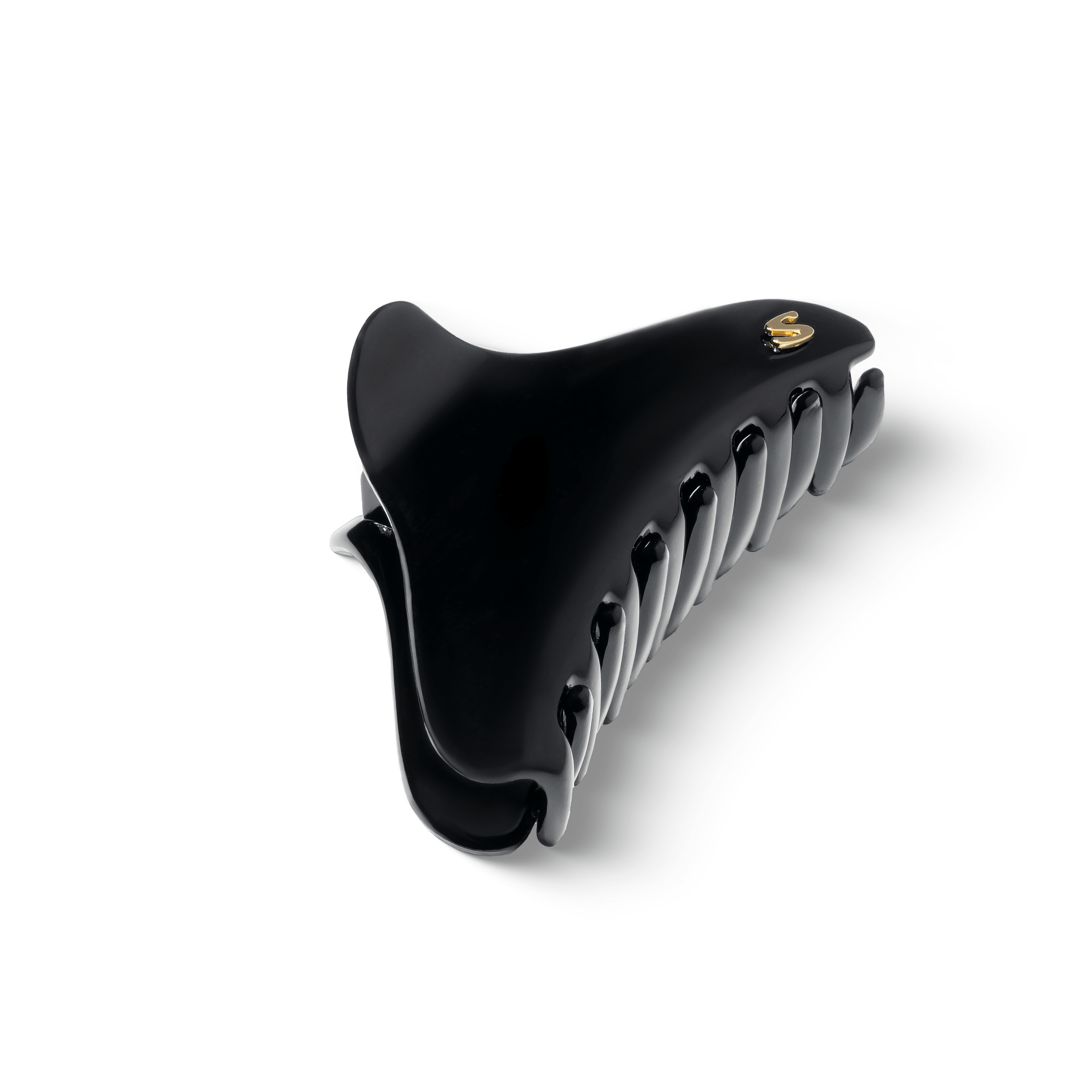 Large French Yoga Hair Clip glossy black — flatlay on dark background