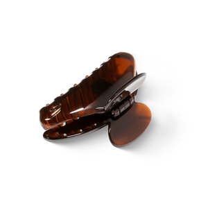 Sacrae Lumière clip tortoise — worn flat across a chignon