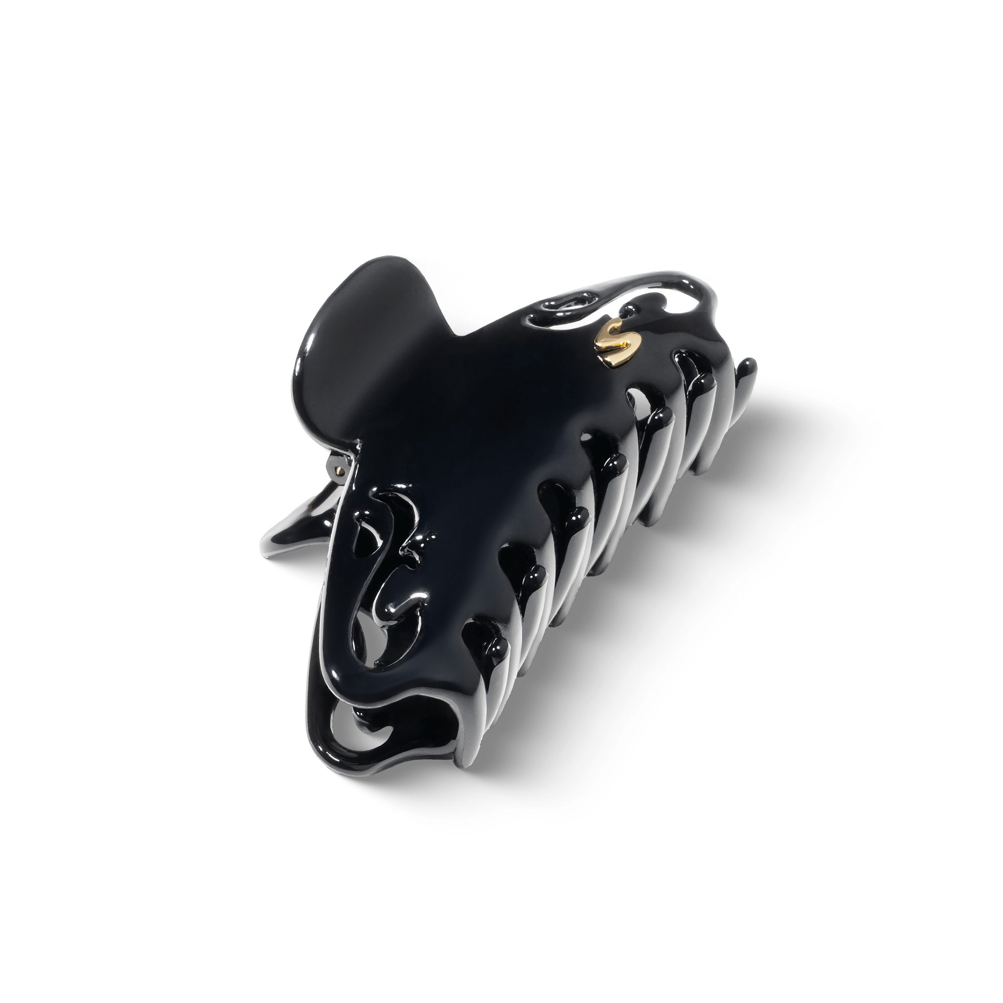 Melissa Large Claw Clip glossy black — flatlay on dark surface, editorial angle