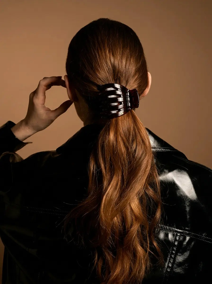 Model wearing Sacrae Marina Medium Claw Clip in Tortoise, low ponytail, back view