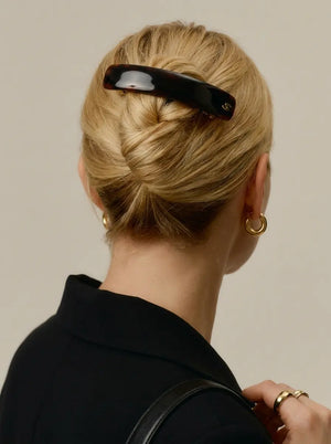 Model wearing Sacrae Jonc Majesté Barrette in Tortoise, French twist, back view