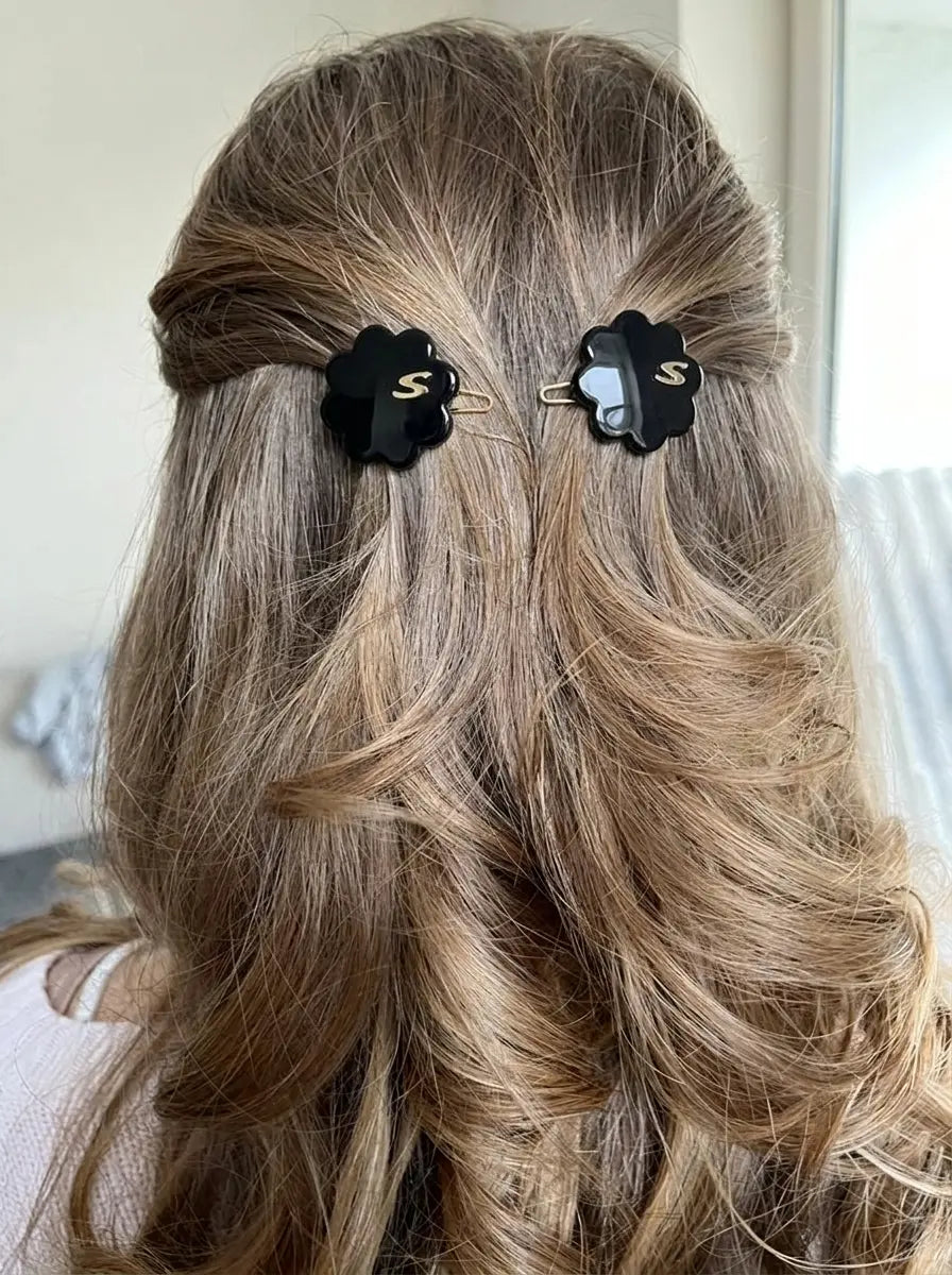 Model wearing Sacrae Petite Fleur Clips in Glossy Black, half-up hairstyle, back view