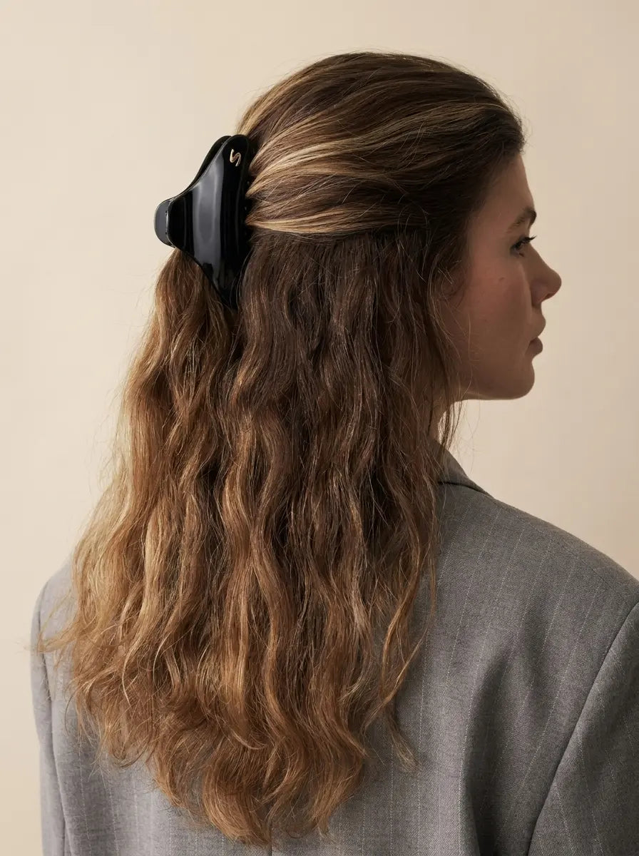 Sacrae Large French Yoga Hair Clip in Glossy Black holding a half-up style, back view