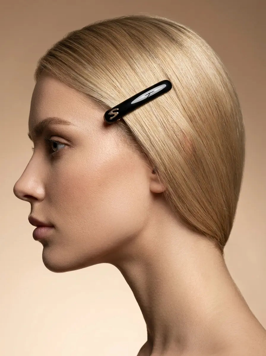 Model with sleek bob wearing Sacrae Jonc Slim Hair Barrette in Glossy Black, side view