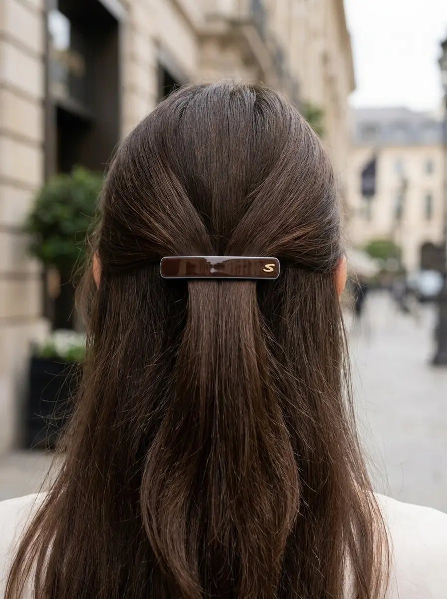 Model wearing Sacrae Barrette M Twilight Mirage Capsule Edition, half-up hairstyle, city, back view
