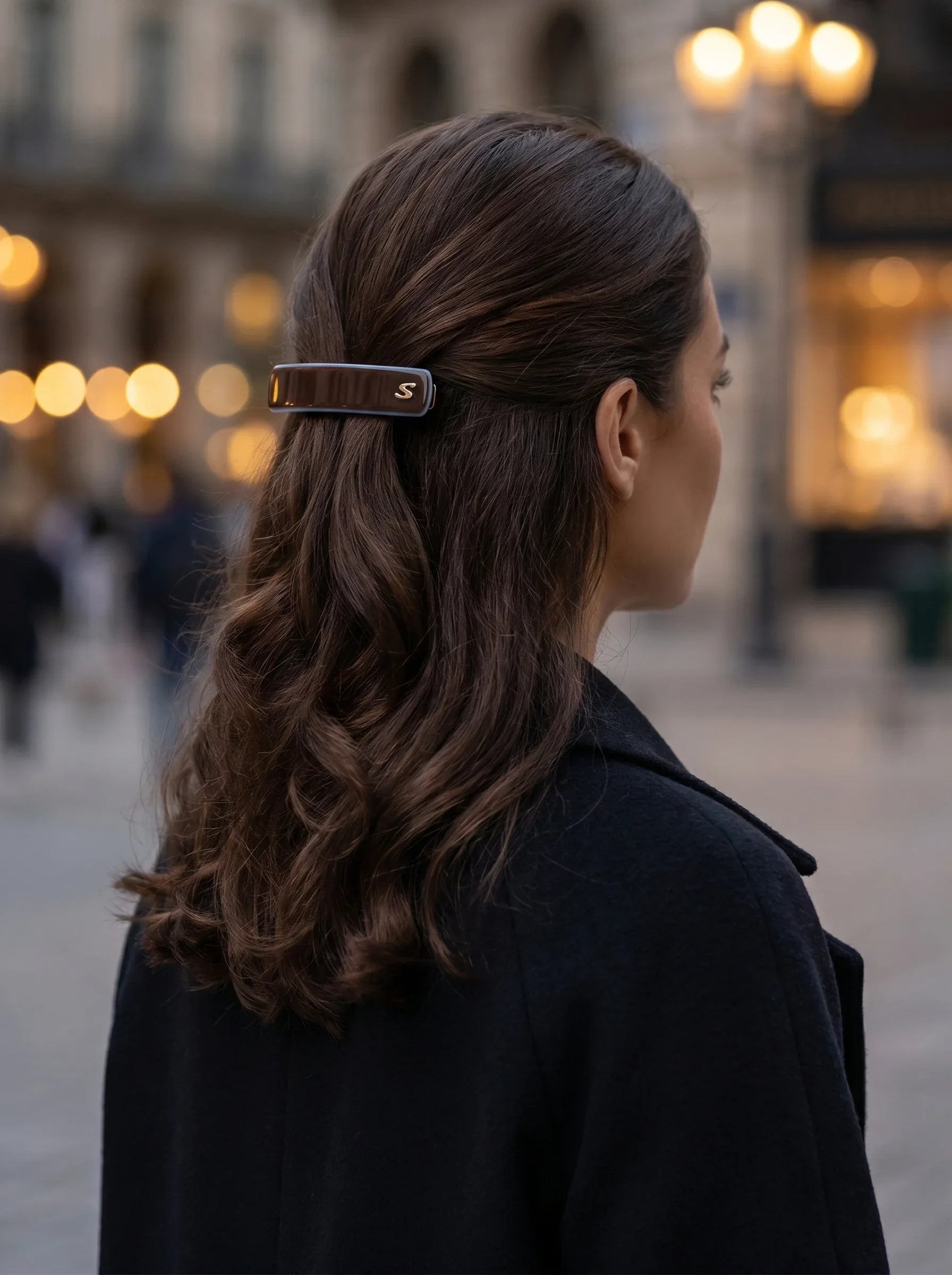 Model wearing Sacrae Barrette M Twilight Mirage Capsule Edition, half-up hairstyle, evening city