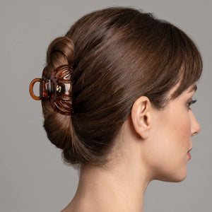 Model wearing Sacrae Lena Small Claw Clip in Tortoise at the temple, studio portrait