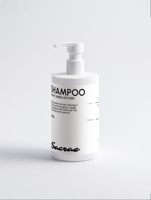 Sacrae Gloss Shampoo Smoky Green Vetiver — white pump bottle, front label, on soft grey