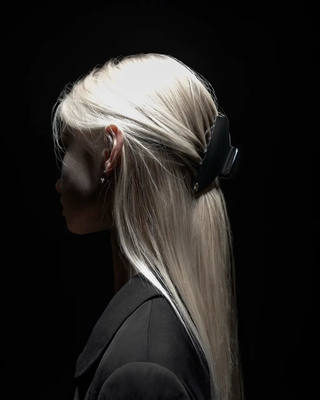 Sacrae silver hair clip — dark background editorial portrait